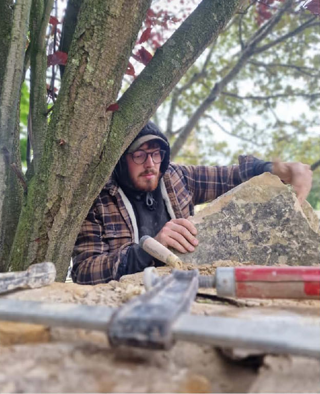 Jamie Underwood shaping a piece of stone